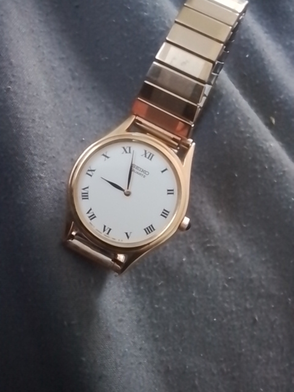 Seiko Gold-Tone Watch with White Dial and Roman Numerals